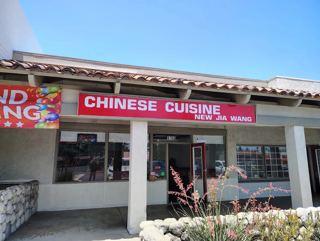 Storefront at the address listed for Bamboo Garden, with a red Chinese Cuisine sign reading New Jia Wang under a tile roof