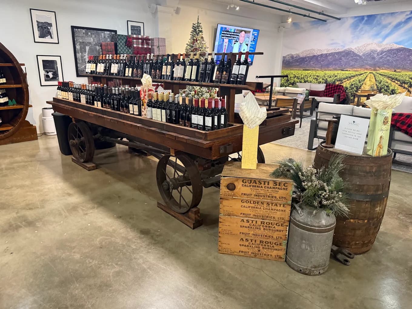 Wine bottles displayed on an antique wooden wagon in the tasting room at d'Ellena Winery & Vineyard