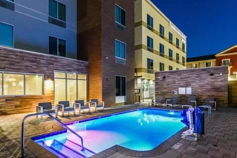 Outdoor pool lit blue at dusk in the courtyard of the Fairfield Inn & Suites Ontario Rancho Cucamonga