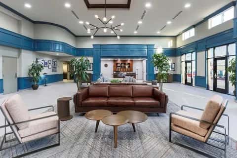 Lobby of the Four Points by Sheraton Ontario-Rancho Cucamonga with blue paneled walls and a brown leather sofa