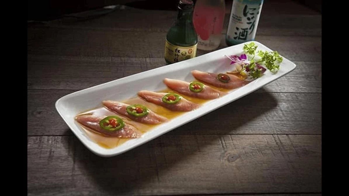 Plate of sashimi slices topped with jalapeno and ponzu sauce at O-Dai-Ba Japanese Grill