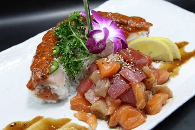 Sushi roll and chopped tuna and salmon with an orchid garnish at Omokase Rancho