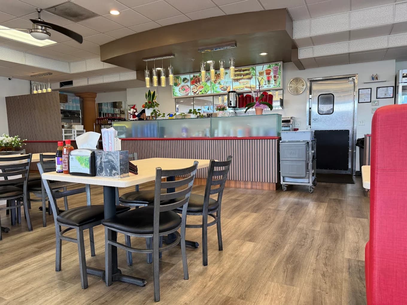 Dining room and front counter with a lit food menu display at Pho LaGi - Vietnamese Restaurant