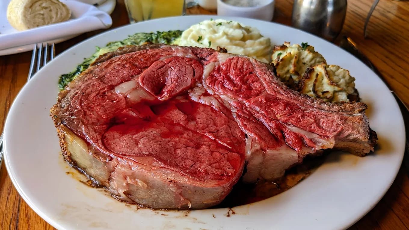 Bone-in prime rib with mashed potatoes and creamed spinach at The Sycamore Inn