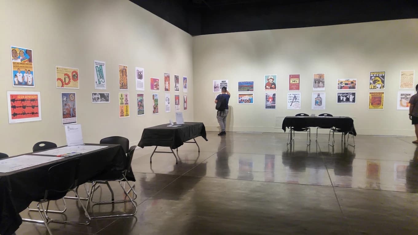 Gallery at Wignall Museum of Contemporary Art with poster prints on the walls and a visitor viewing them
